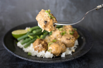 Eating Thai Curry Meatballs with White Rice and Green Beans