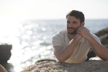 Fototapeta na wymiar Smiling man outdoor portrait near the sea