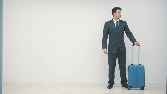 Man waiting for trip, he forgot something and looking for it in his jacket.