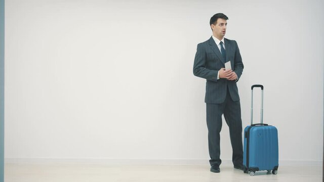 4k slowmotion of male passenger waiting in queue to check in and drop off luggage over white background.