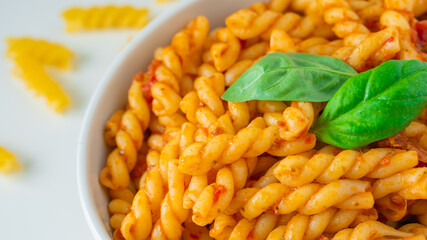 Homemade fresh Italian food with gemelli traditional pasta noodle with bolognese red rosso pesto sauce made from healthy organic tomato spice chili vegan cook recipe