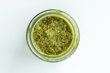 Background homemade cooking recipe green pesto pasta organic healthy food sauce in glass jar made from fresh basil leaf herb parmesan cheese nuts for healthy vegetarian vegan meal