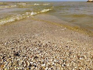 Rocky and sandy beach on sunset