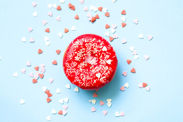 Colored donuts with colorful sprinkles on blue background. Donut day concept. Close-up