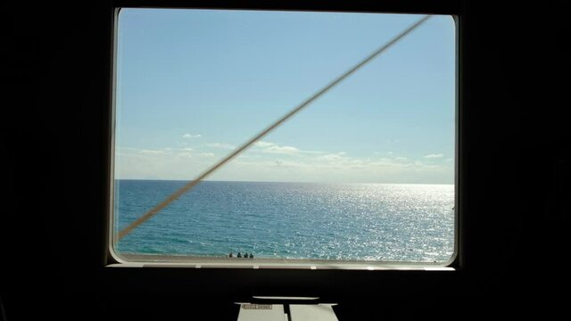 Look out from the train window at empty beach and Mediterranean Sea at summer. 