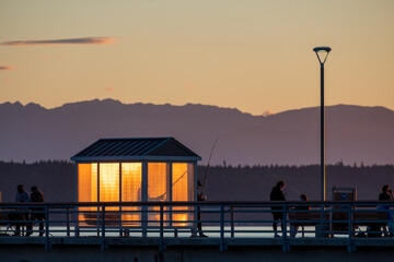 A little break area glows in the sunset light on a fishing pier