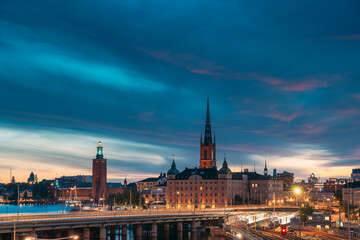 Fototapeta na wymiar Stockholm, Sweden. Scenic View Of Stockholm Skyline At Summer Evening Night. Famous Popular Destination Scenic Place Under Dramatic Sky In Night Lights. Riddarholm Church, City Hall, Subway Railway