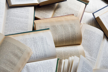 A pile of books lies on the floor