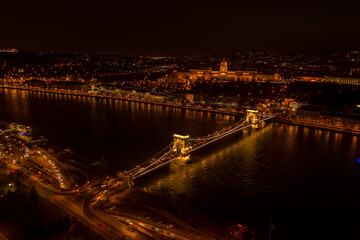 Fototapeta na wymiar Aerial drone shot of Chain bridge over Danube and National Gallery with lights in Budapest night