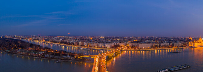 Fototapeta na wymiar Panoramic Aerial drone shot of Margaret Bridge with lights on over Danube river during Budapest sunset