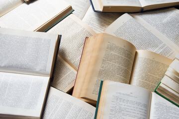 A pile of books lies on the floor