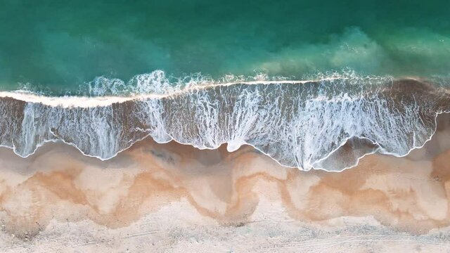 4k HD Aerial Footage of Clear Aqua Blue Waves Crashing on Sandy Seashore While Moving Along Coastline. Soothing, Relaxing, Tranquil Nature Ocean Scene 