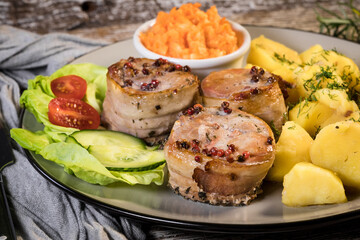 Pork tenderloin wrapped in bacon.