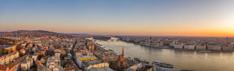 Panoramic aerial drone shot of Budapest skyline sunrise over Danube river with Hungarian Parliament