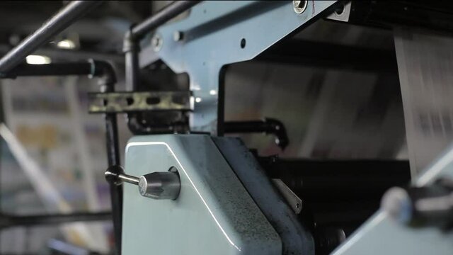 Print Press Machine Close Up with Moving Newspapers Detail