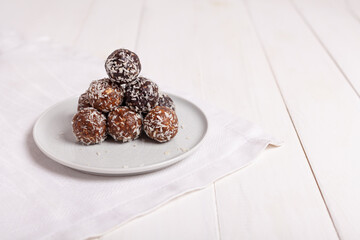 Energy balls on a plate on a white background