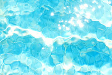 blurry blue wavy water surface with sun flare. blue water texture