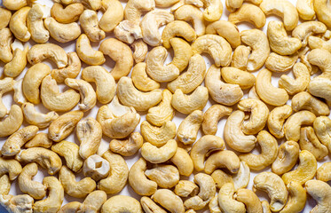 Scattered cashew nuts on a white background.