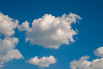 Naklejka na ściany i meble White cumulus clouds. Clouds on the blue sky. Natural sky background.