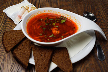 Ukrainian borsch with bacon and dark bread