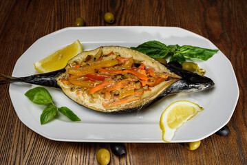 
baked fish and vegetables in lemon juice