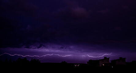 Lightning in the night sky in rural environment