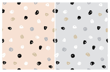 Simple Irregular Freehand Doodle Vector Patterns. Black, White and Gold Hand Drawn Spots on a  Light Gray and Light Salmon Pink Background. Infantile Style Abstract Dotted Vector Print. Geometric Back