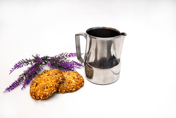 Pitcher milkman steel. lavender and spicy oatmeal cookies on a white background - obrazy, fototapety, plakaty