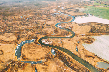 Aerial View Of Dry Grass And Partly Frozen River Landscape In Late Autumn Day. High Attitude View. Marsh Bog. Drone View. Bird's Eye View