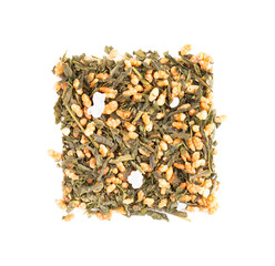 Japanese green tea Genmaicha, isolated on white background. Tea leaves with roasted brown rice. Organic tea. Top view. Close up.