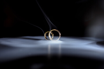 wedding rings on a black background