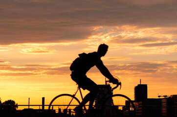 Silhouette Man With Bicycle Against Sky During Sunset