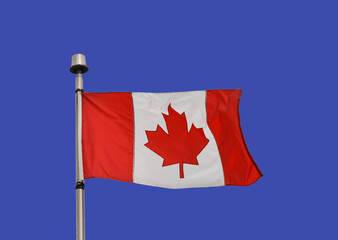 Canadian national flag, the Maple Leaf, isolated against a deep blue sky. No people