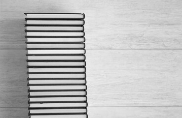 books, make elegant shape, black and white, wooden background, top view