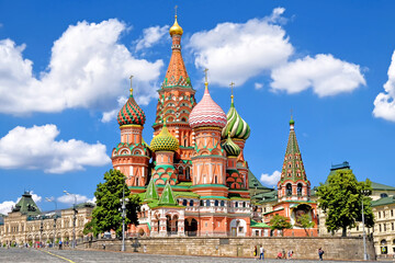 Fototapeta na wymiar famous moscow city russia landmark saint basil's cathedral on red square next to kremlin on summer against blue sky with clouds background. Street wide view of russian nation historic heritage