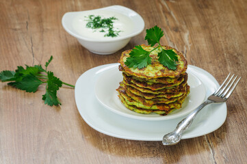Zucchini fritters on a plate. Serving breakfast. Selective focus