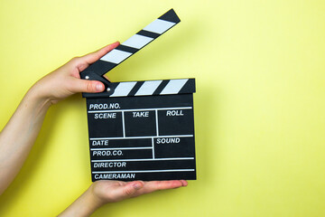 Movie clapper on yellow background, cinema concept