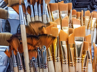 Group of artistic paintbrushes for artist. New paint brushes on shelf display in stationery shop....