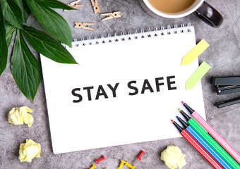 Stay safe on a notebook with a cup of coffee, compressed sheets, crayons, stapler