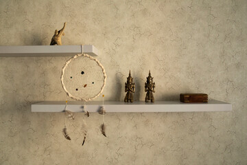 Stylish and modern element of interior. Wall shelf with decor statuettes, dream catcher and jewelry...