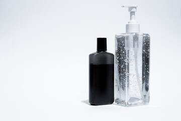 A hand sanitizer gel and liquid soap in bottles isolated in white background