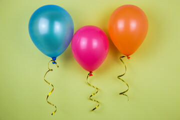 Different colors of balloons. Balloons on a yellow background