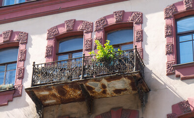 An old balcony with flowers illuminated by the sun