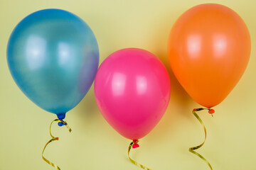 Different colors of balloons. Balloons on a yellow background