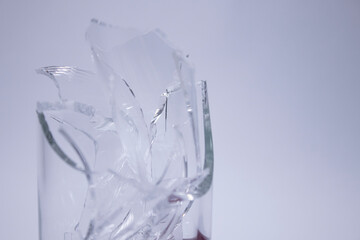 fragments of a broken glass in a broken glass on a white background. Isolated. Copy space. High quality photo