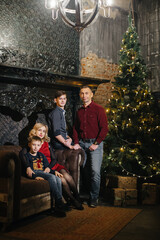 A family with two sons in a new year or Christmas interior