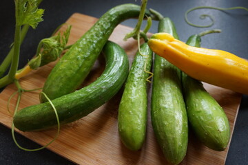 Organic courgettes on a wooden board.