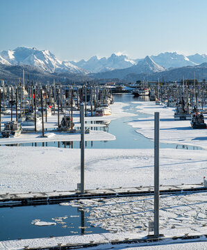 Mostly icy view down boat channel in Homer Alaskas small boat harbor