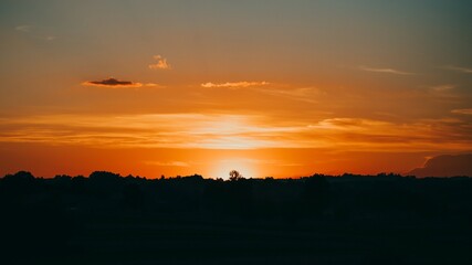 Beautiful sunset with silhouettes of trees in the evening. 16:9 panoramic format