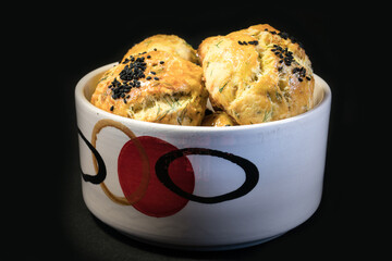 Homemade Pastry in white serving plate. On black background